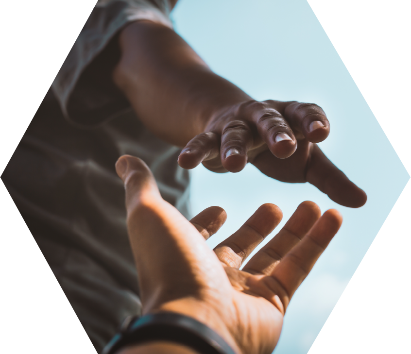 hands reaching for one another against blue sky